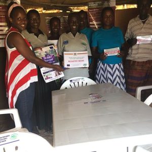 Peruth of NAPE handing over tools of work to the care takers of Concord safe space in Bulisa District.